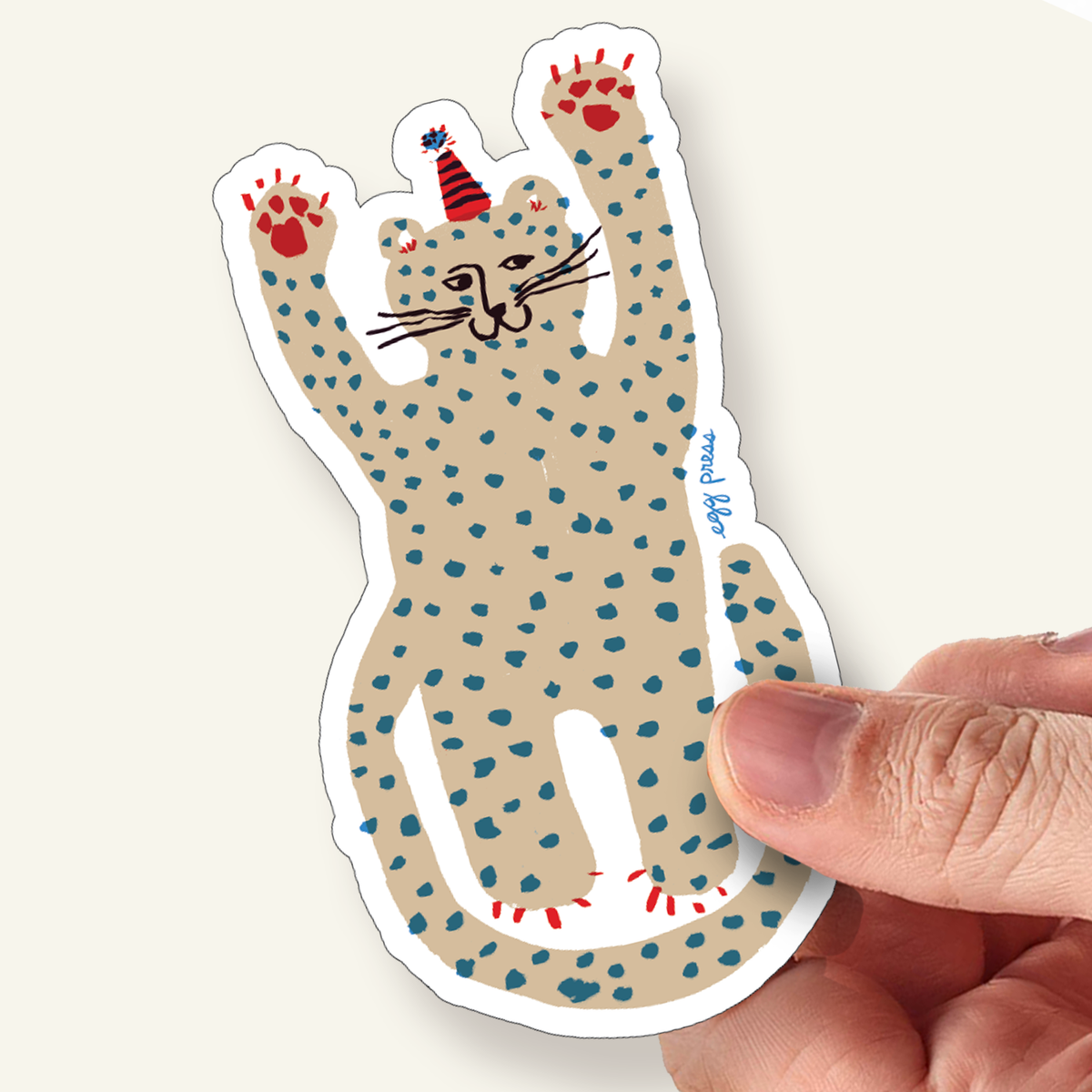 Party cheetah vinyl sticker of a spotted animal with red paws and a party hat on a white background by Egg Press